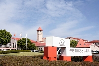 オレンジ色の外観と時計台が特徴の県立こども病院＝安曇野市