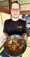 三幸ラーメンを手にする上野さん