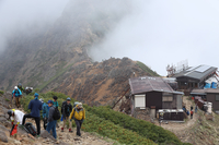 八ケ岳連峰・赤岳へ向かう稜線上を歩く登山者＝6月