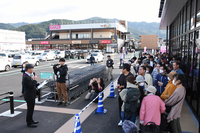 オープン前に並んだ買い物客を前にあいさつする後山店長(左手前)